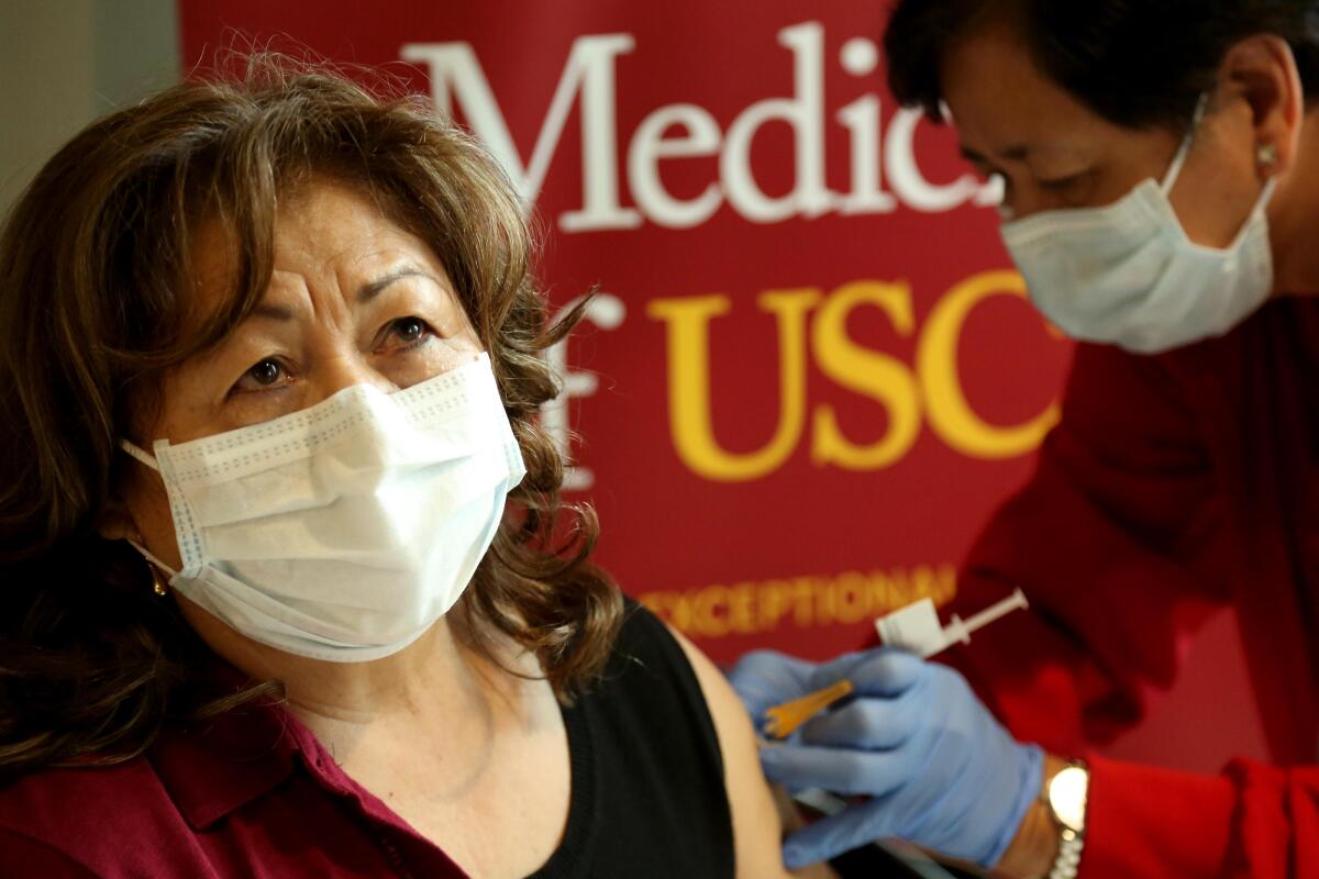 A woman receives a vaccine