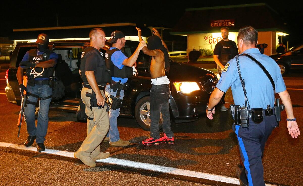 A protester is arrested on West Florissant Avenue in Ferguson, Mo., on Aug. 20