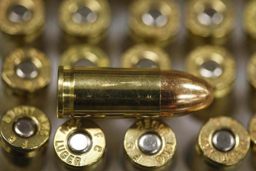 A 9-millimeter bullet rests on top of others in a box. A California lawmaker wants to put a five-cent tax on each bullet.