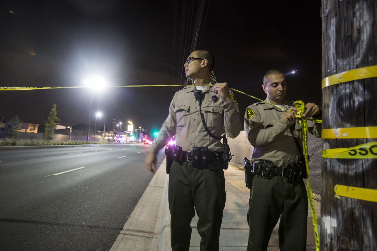 Police put up yellow tape outside Chris' & Pitt's barbecue restaurant in Downey.