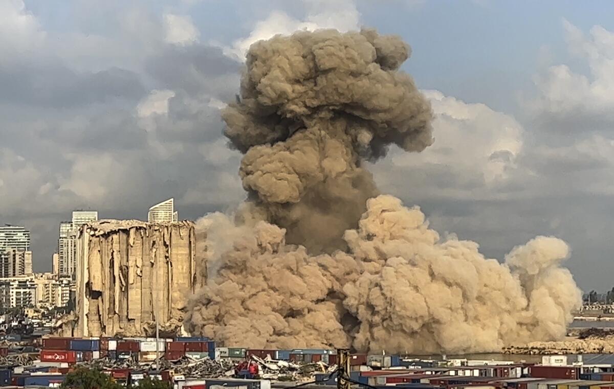 Smoke and dust rising from collapsing silos in Beirut's port