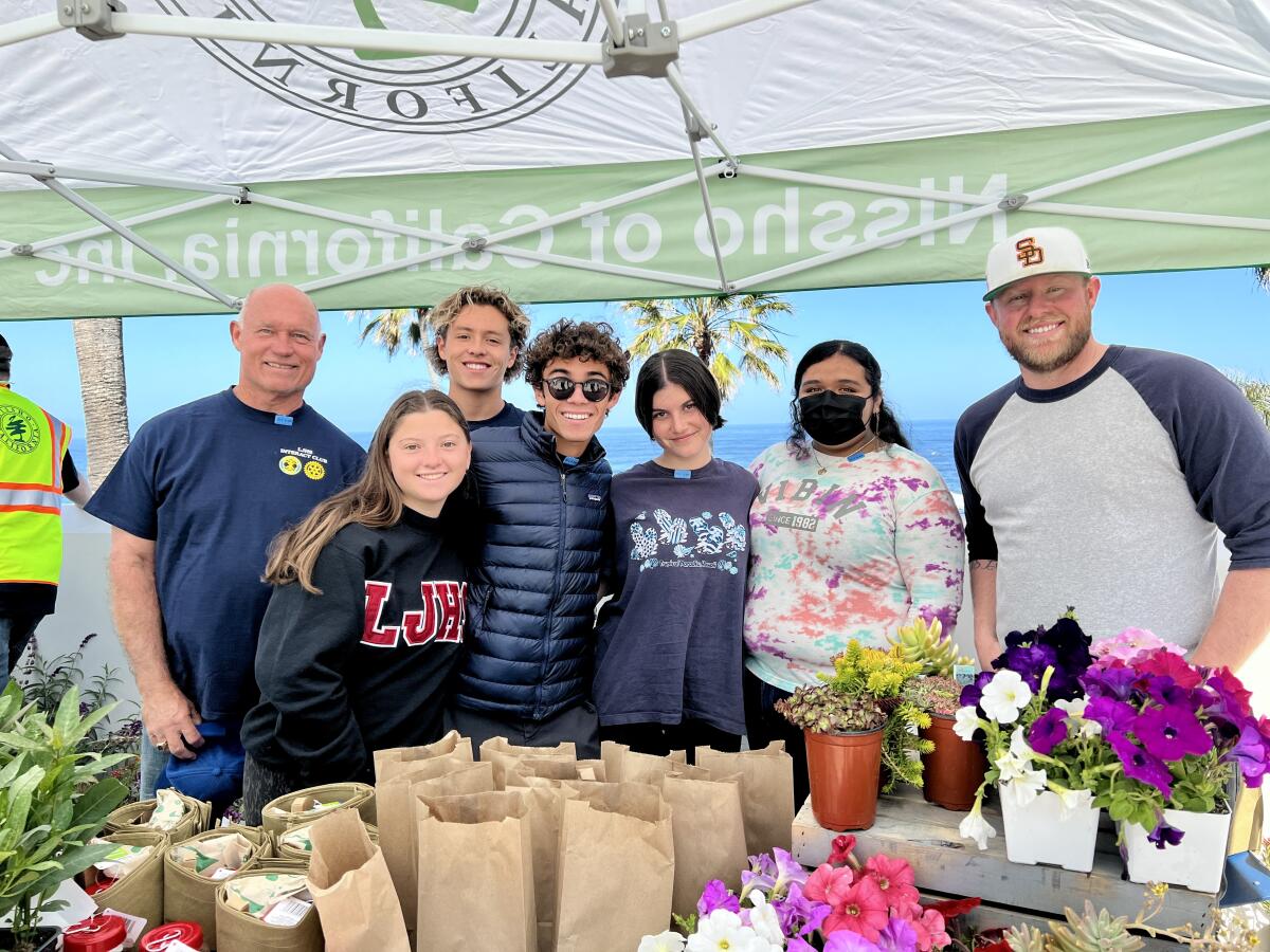 Members of the La Jolla High School Interact Club meet with Ben Colton (right) of Nissho California on Enhance La Jolla Day.