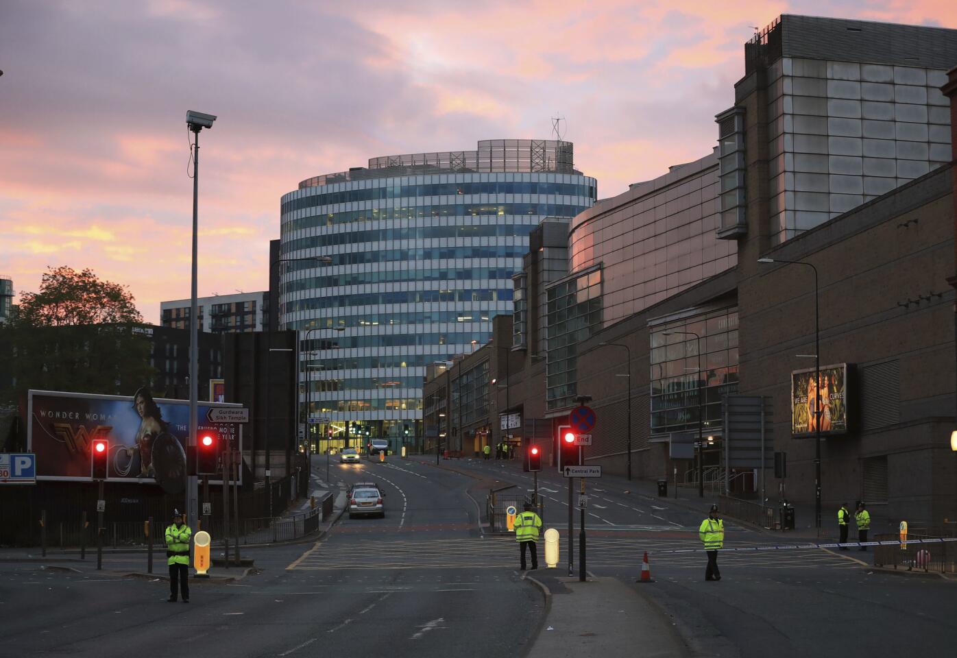 Police stand guard at dawn, after a blast at the Manchester Arena on May 23, 2017.