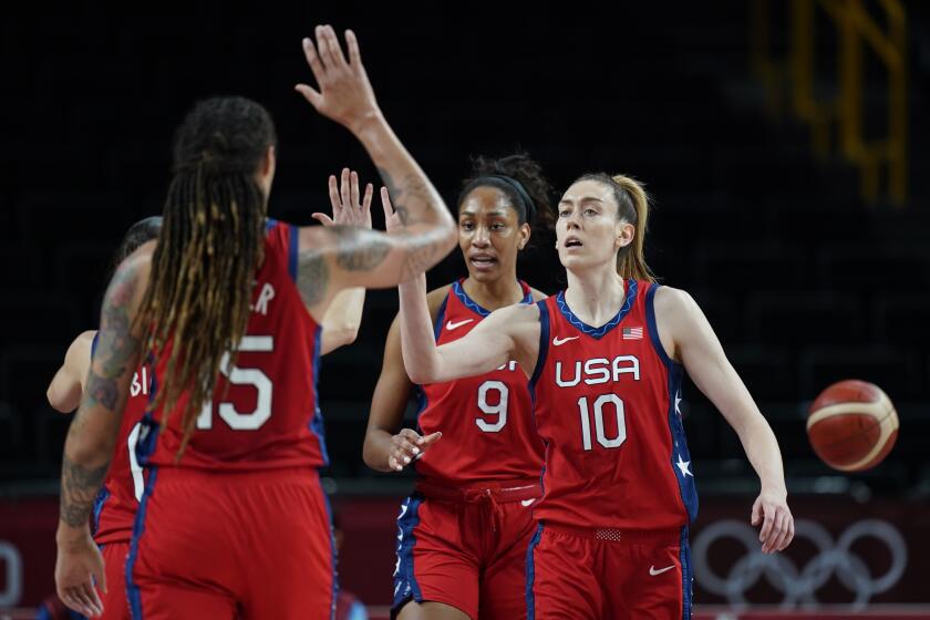 United States's Breanna Stewart high fives with teammates during a game against Australia at the Tokyo Olympics