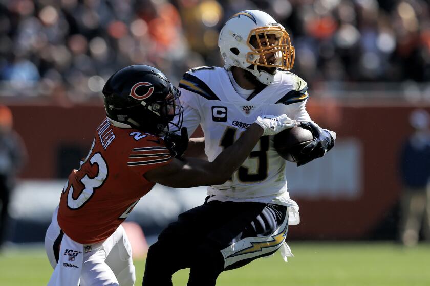 CHICAGO, ILLINOIS - OCTOBER 27: Keenan Allen #13 of the Los Angeles Chargers runs with the ball while being tackled by Kyle Fuller #23 of the Chicago Bears in the second quarter at Soldier Field on October 27, 2019 in Chicago, Illinois. (Photo by Dylan Buell/Getty Images)