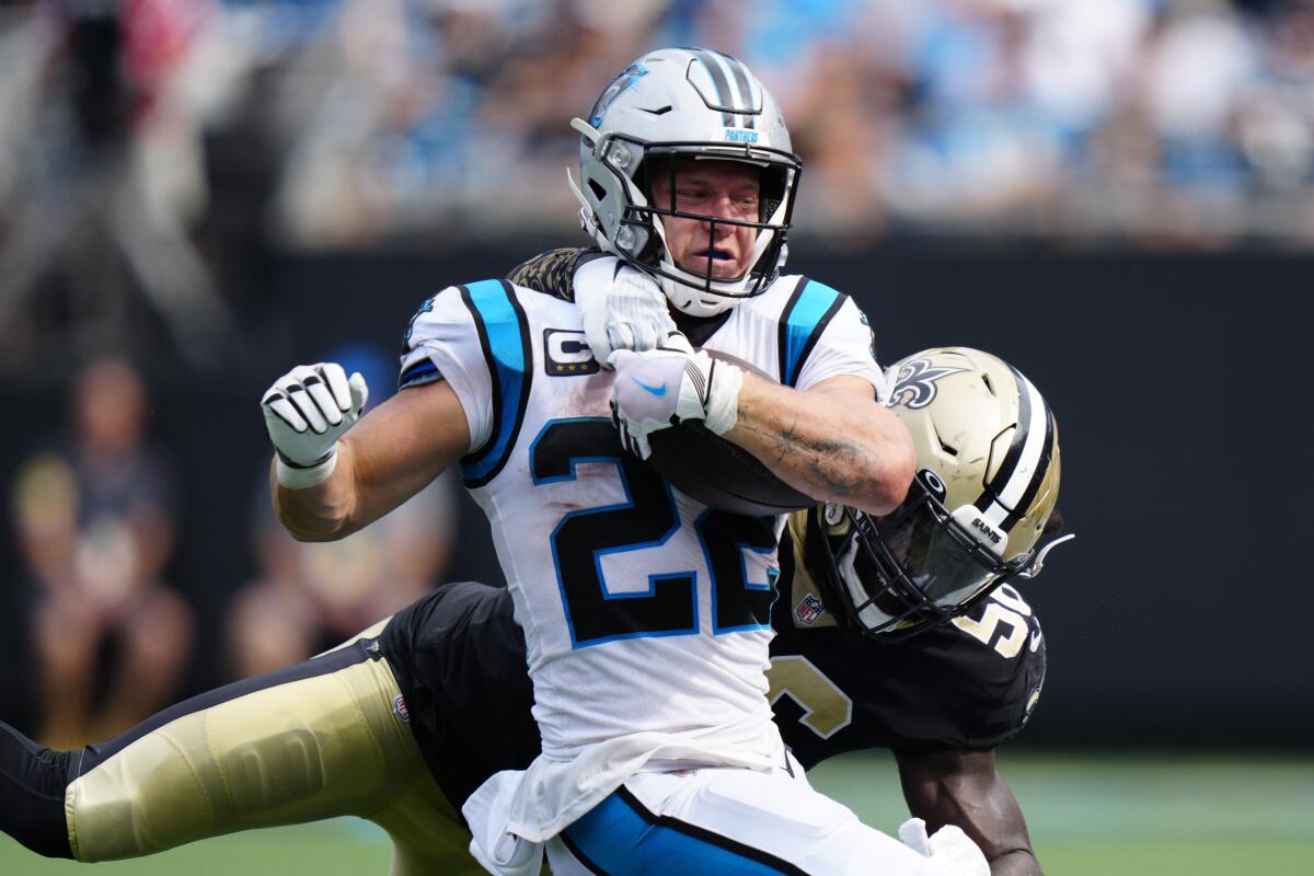 Carolina Panthers running back Christian McCaffrey is tackled by New Orleans Saints outside linebacker Demario Davis during the second half of an NFL football game Sunday, Sept. 19, 2021, in Charlotte, N.C. (AP Photo/Jacob Kupferman)