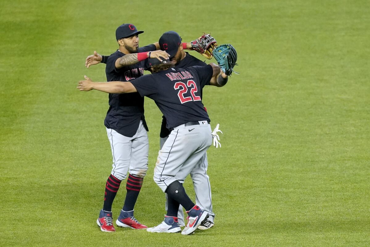 Cleveland Indians outfielders celebrate after their baseball game against the Kansas City Royals Wednesday, May 5, 2021, in Kansas City, Mo. The Indians won 5-4. (AP Photo/Charlie Riedel)