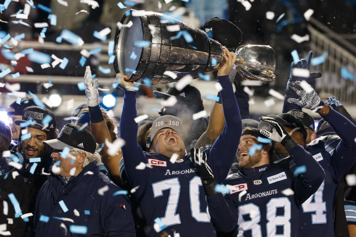 Lirim Hajrullahu raises the Grey Cup after kicking a last-minute field goal to give the Toronto Argonauts the Canadian Football League championship in 2017.