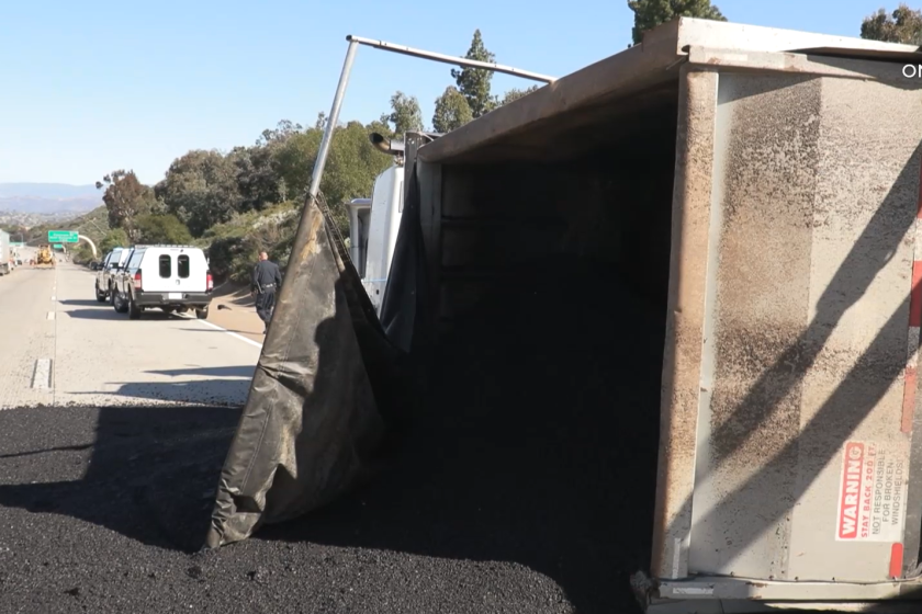 Gravel spilled onto the slow lane of northbound Interstate 15 near Rancho Bernardo Thursday morning after a truck overturned.