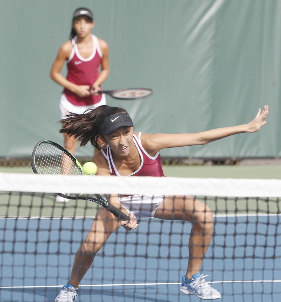 La Canada's Maya Urata gets low at the net for a return against University in a doubles match with teammate Eliana Hanna in the CIF Southern Section Individual Tennis Championships second round of sixteen in a match against tournament on Wednesday, November 28, 2018.