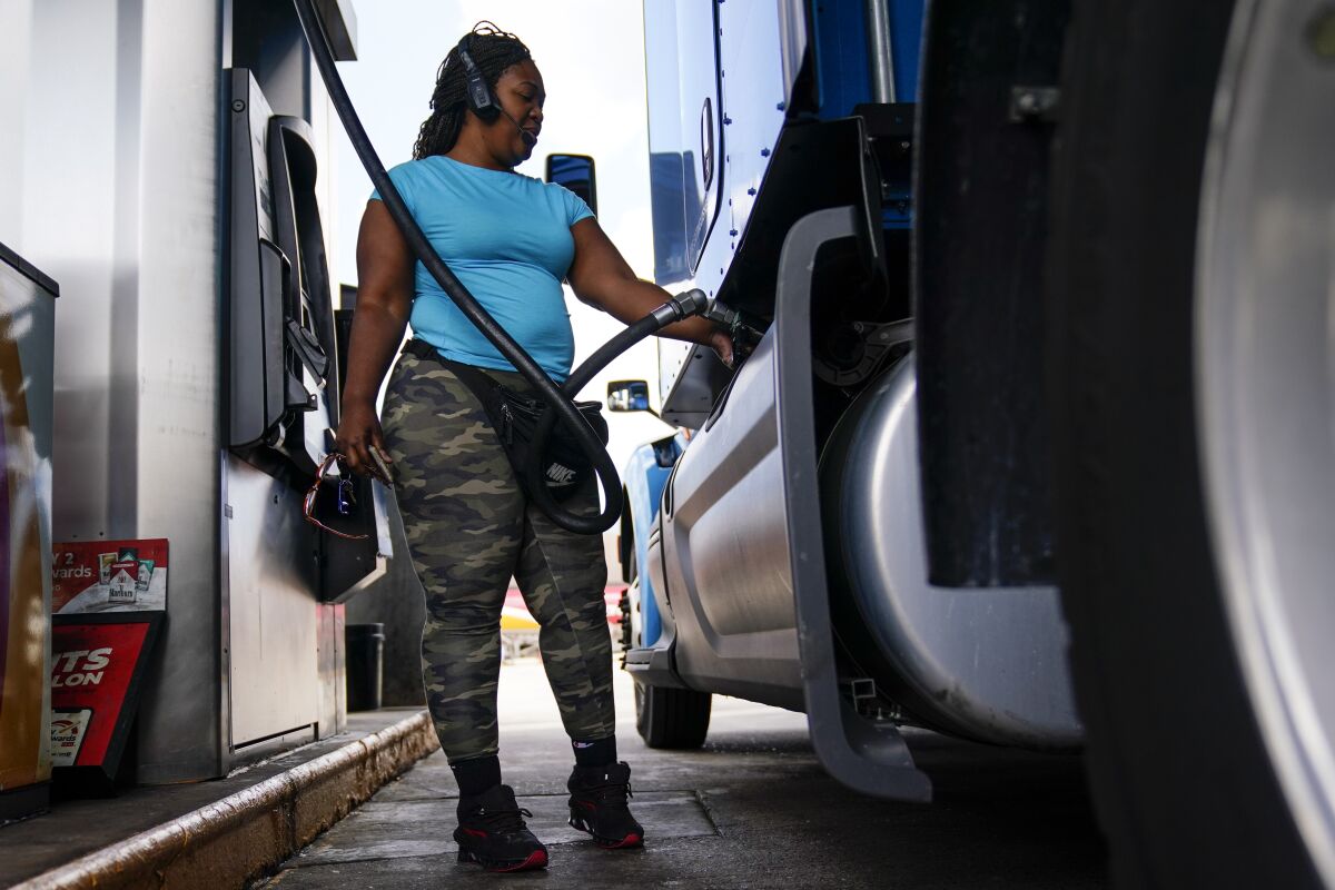 Delores Bledsoe, of Houston, Texas, fuels up her rig at a truck stop in Carlisle, Pa., Wednesday, July 13, 2022. (AP Photo/Matt Rourke)