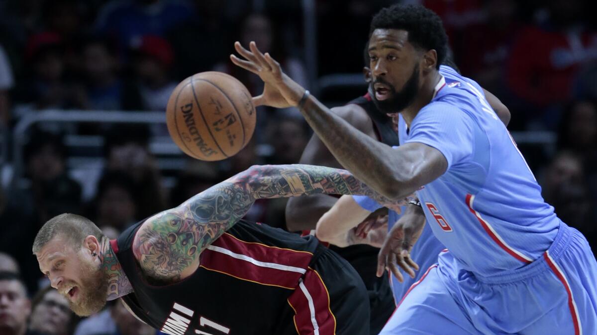 Clippers center DeAndre Jordan, right, steals the ball from Miami Heat forward Chris Anderson during a game at Staples Center on Sunday.