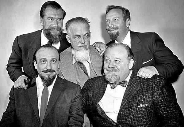 Mitch Miller with four other bearded men: Burl Ives, seated, Cmdr. Edward Whitehead, top left, mystery author Rex Stout, center, and musician Skitch Henderson. See full story