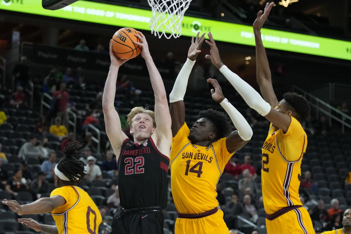 Stanford's James Keefe shoots against Arizona State's Enoch Boakye and Alonzo Gaffney.