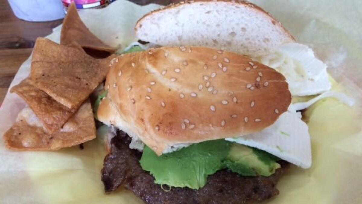 A cemita with a pounded sheet of beef bigger than the bun.