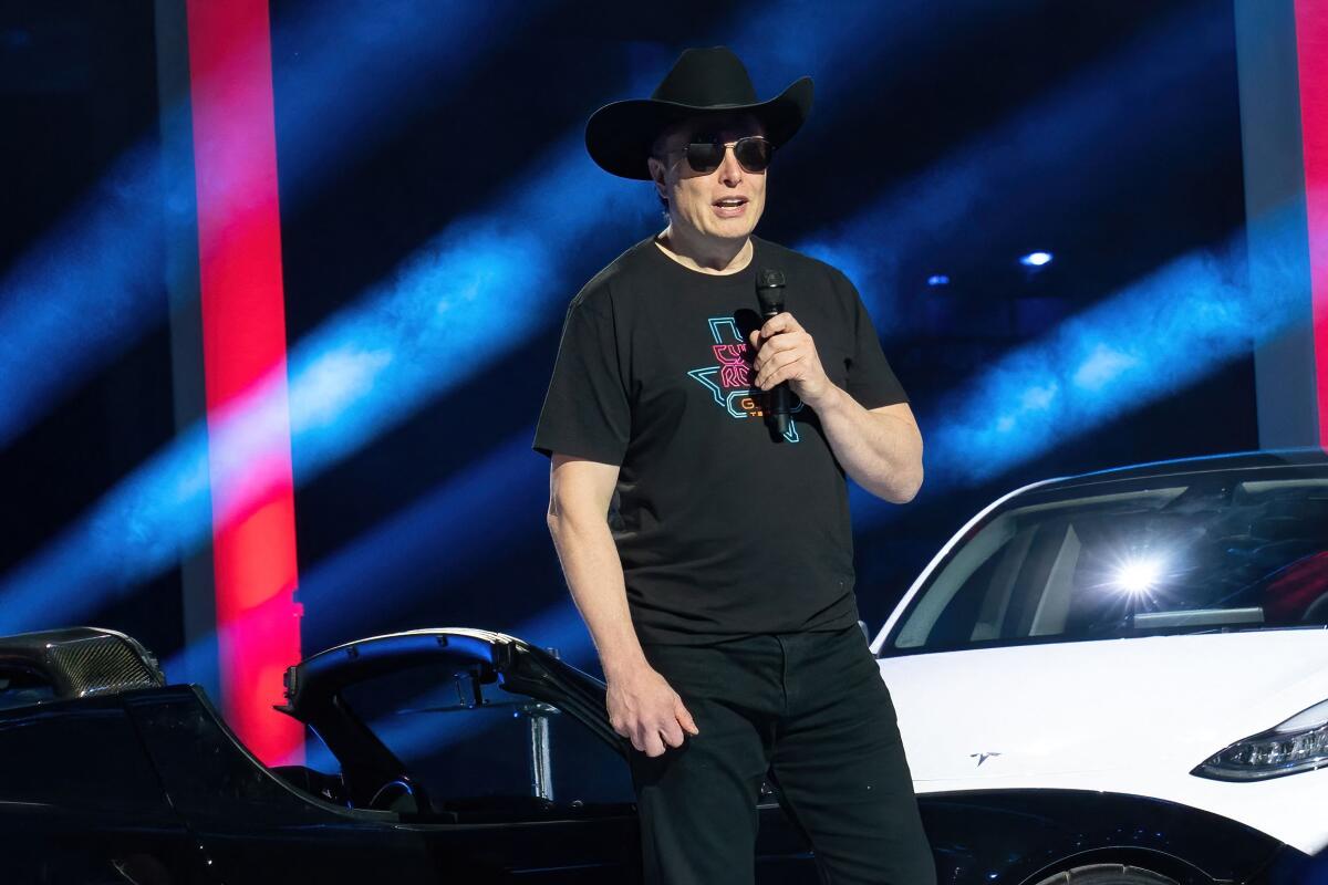 CEO of Tesla Motors Elon Musk speakswearing a cowboy hat