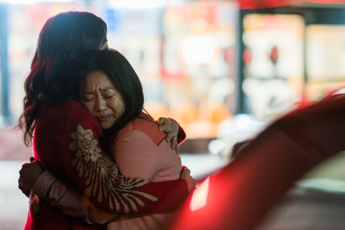"Everything Everywhere All at Once" still image of Michelle Yeoh and Stephanie Hsu hugging at night in a parking lot.
