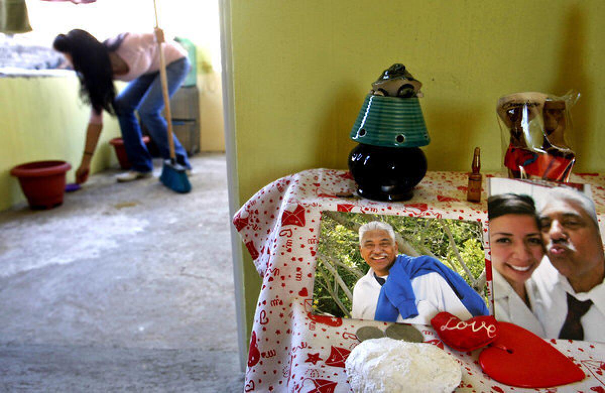 Ana Herrejon cleans her room, which is decorated with pictures of her husband, who lives in Los Angeles. When Ana was 7, her mother took her to the U.S., where she graduated from UC Berkeley, then married a man 41 years her senior. Their application for a visa to legalize Ana's immigration status was turned down; the U.S. official thought their marriage was a fraud.