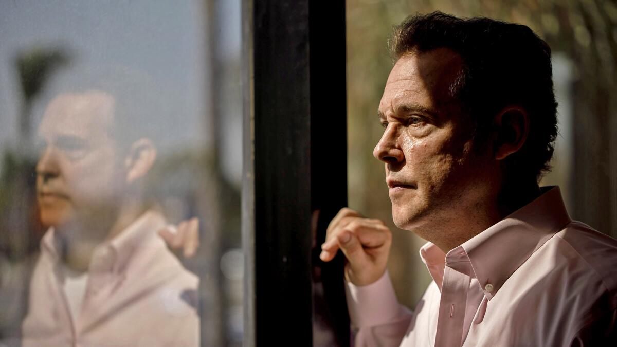 Alex Meruelo, a longtime L.A. investor, peers out the window of his offices in Downey. He is the new owner of the SLS Las Vegas, a historic but troubled casino on the Las Vegas Strip.
