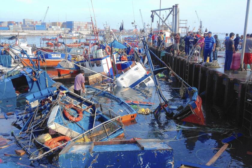 Sinking fishing boats in a cove at Iquique, northern Chile, after the magnitude 8.2 earthquake.