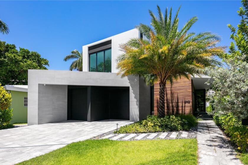 Set on Sunset Lake, the modern home built in 2019 includes a movie theater, swimming pool and private concrete dock.