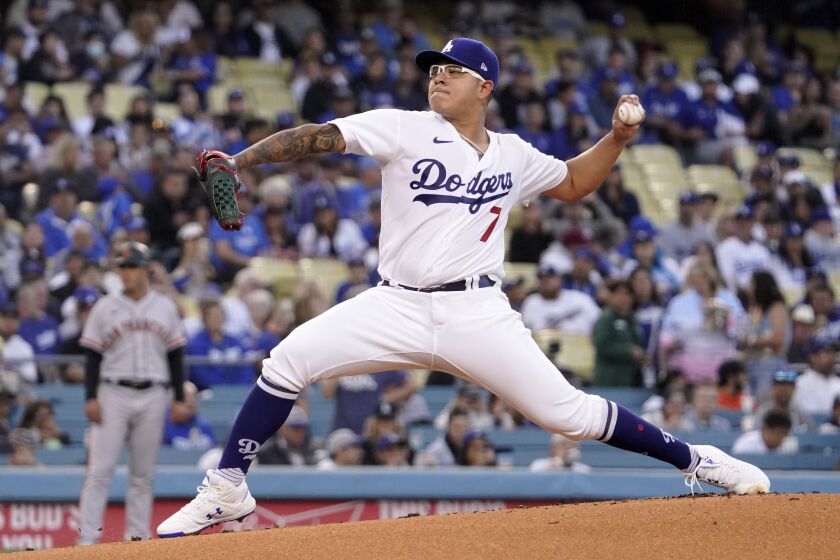 Los Angeles Dodgers starting pitcher Julio Urias throws to the plate during the first inning.
