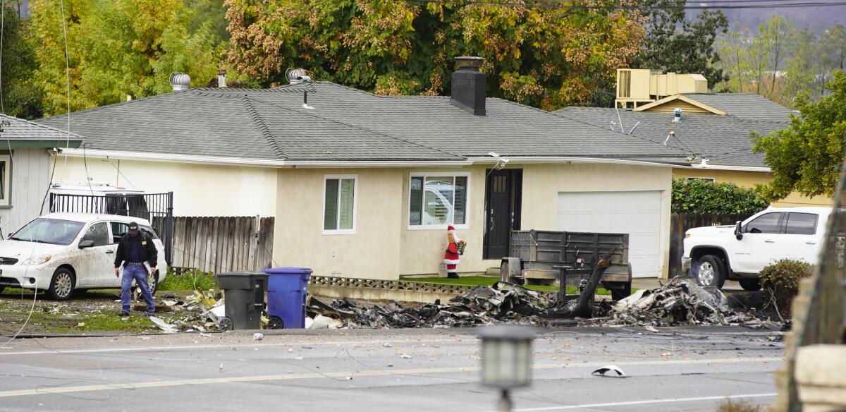 Debris from a Learjet crash litters a street