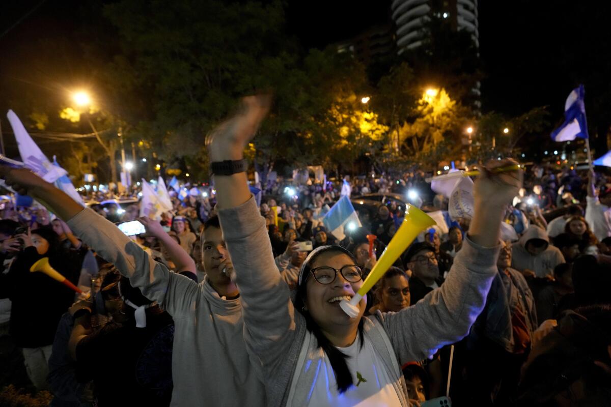 Supporters of presidential candidate Bernardo Arévalo celebrate preliminary results of a runoff election in Guatemala City.