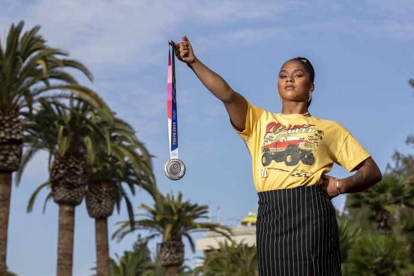 Los Angeles, CA - August 11: Team U.S.A. olympic gymnast Jordan Chiles holds her Olympic silver medal for artistic gymnastics, women's team U.S.A., at the Sheraton Universal Hotel on Wednesday, Aug. 11, 2021 in Los Angeles, CA. (Allen J. Schaben / Los Angeles Times)