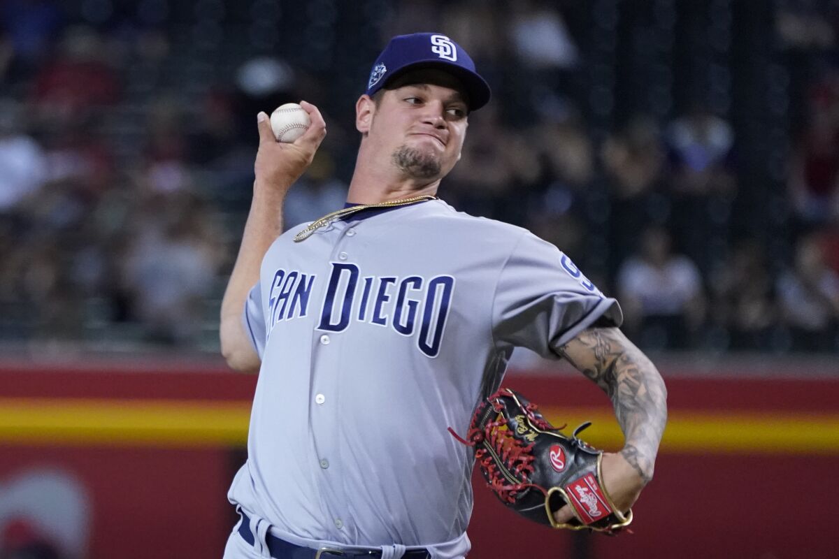 San Diego Padres relief pitcher Michel Baez (49) throws against the Arizona Diamondbacks in the seventh inning during a baseball game, Monday, Sept. 2, 2019, in Phoenix. (AP Photo/Rick Scuteri)
