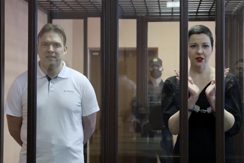Belarus' opposition activists Maria Kolesnikova, right, and Maxim Znak attend a court hearing in Minsk, Belarus, Monday, Sept. 6, 2021. A court in Belarus on Monday sentenced two leading opposition activists to lengthy prison terms, the latest move in the relentless crackdown Belarusian authorities unleashed on dissent in the wake of last year's months-long anti-government protests. Maria Kolesnikova, a top member of the opposition Coordination Council, has been in custody since her arrest last September. A court in Minsk found her guilty of conspiring to seize power, creating an extremist organization and calling for actions damaging state security and sentenced her to 11 years in prison. Znak was sentenced to 10 years in prison. (Ramil Nasibulin/BelTA pool photo via AP)