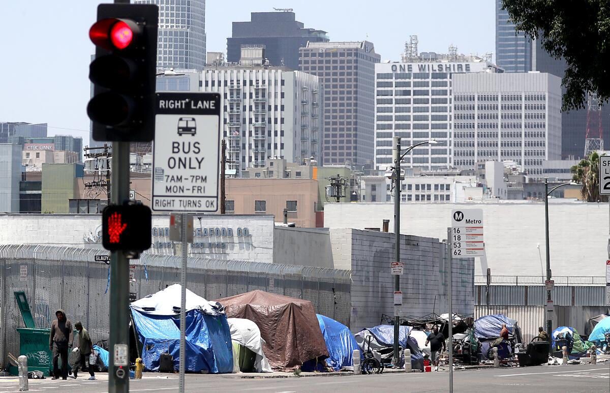 Tents that serve as shelter for homeless people line the sidewalk in downtown Los Angeles.