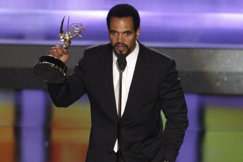 FILE- In this June 20, 2008, file photo Kristoff St. John accepts the award for outstanding supporting actor in a drama series for his work on "The Young and the Restless" at the 35th Annual Daytime Emmy Awards in Los Angeles. John has died at age 52. Los Angeles police were called to John's home on Sunday, Feb. 3, 2019, and his body was turned over to the Los Angeles County coroner. The cause of death was not available. (AP Photo/Matt Sayles, File)