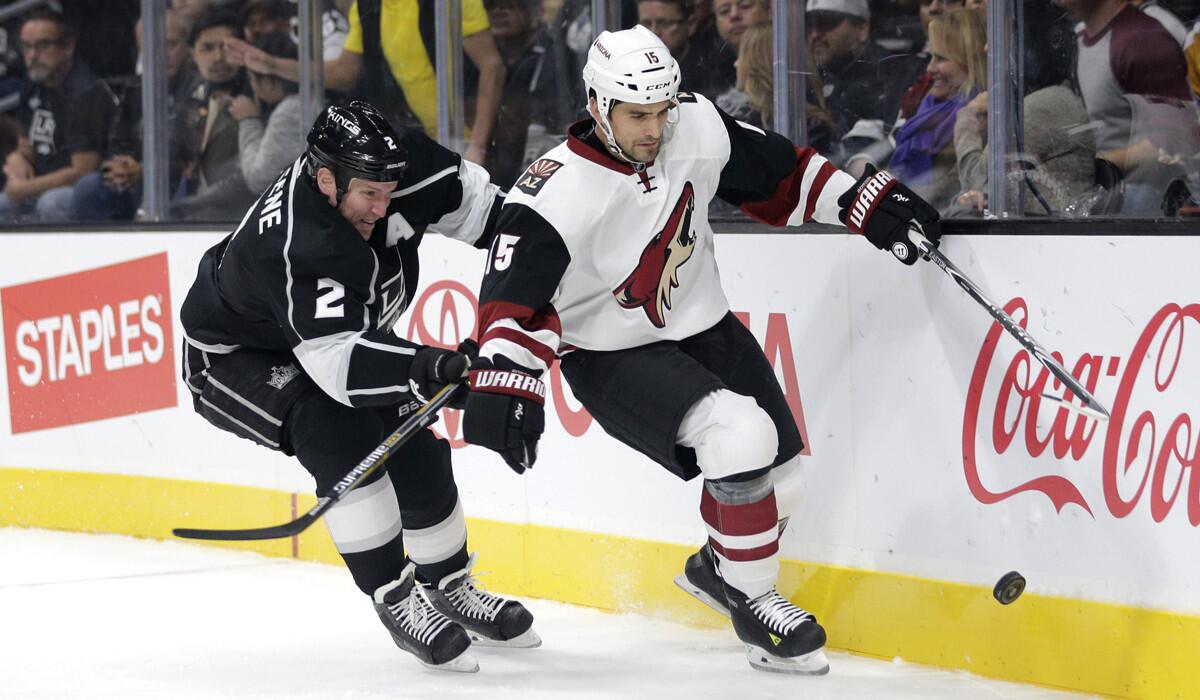Arizona Coyotes' Boyd Gordon, right, is defended by Los Angeles Kings' Matt Greene during the first period on Friday.