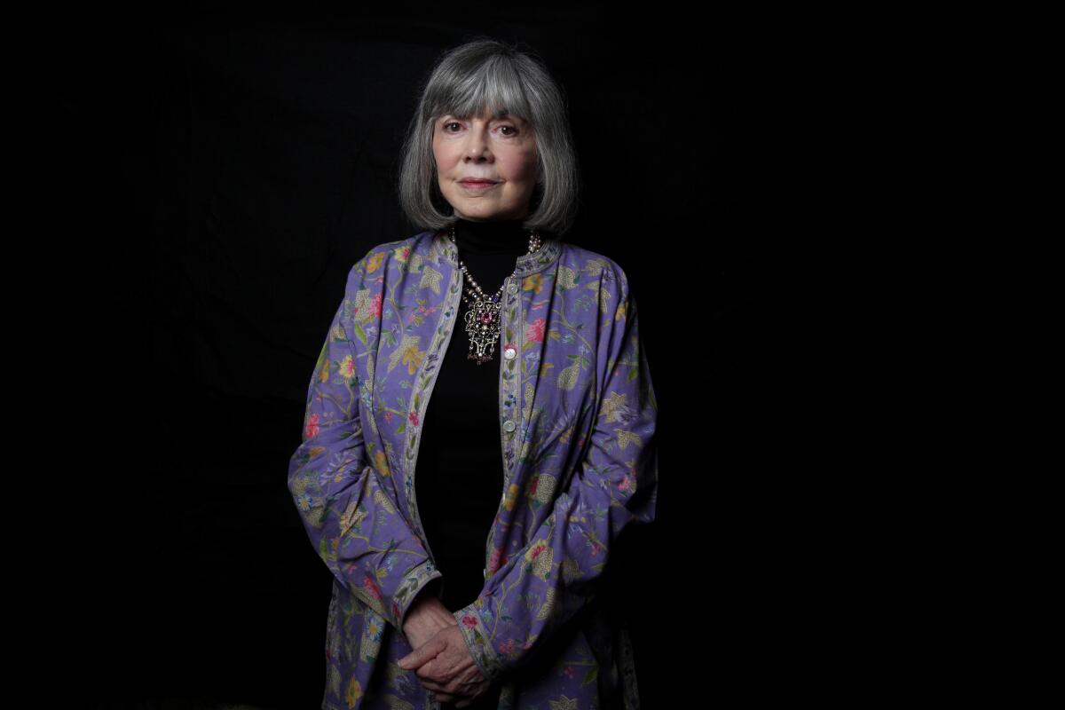 A portrait of Anne Rice in a purple jacket