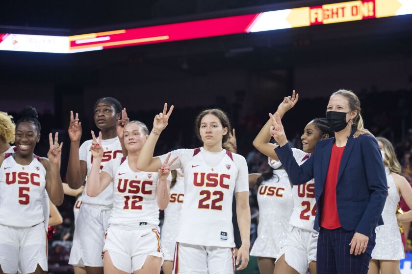Southern California head coach Lindsay Gottlieb, right, and the players celebrate the team's win over Hawaii
