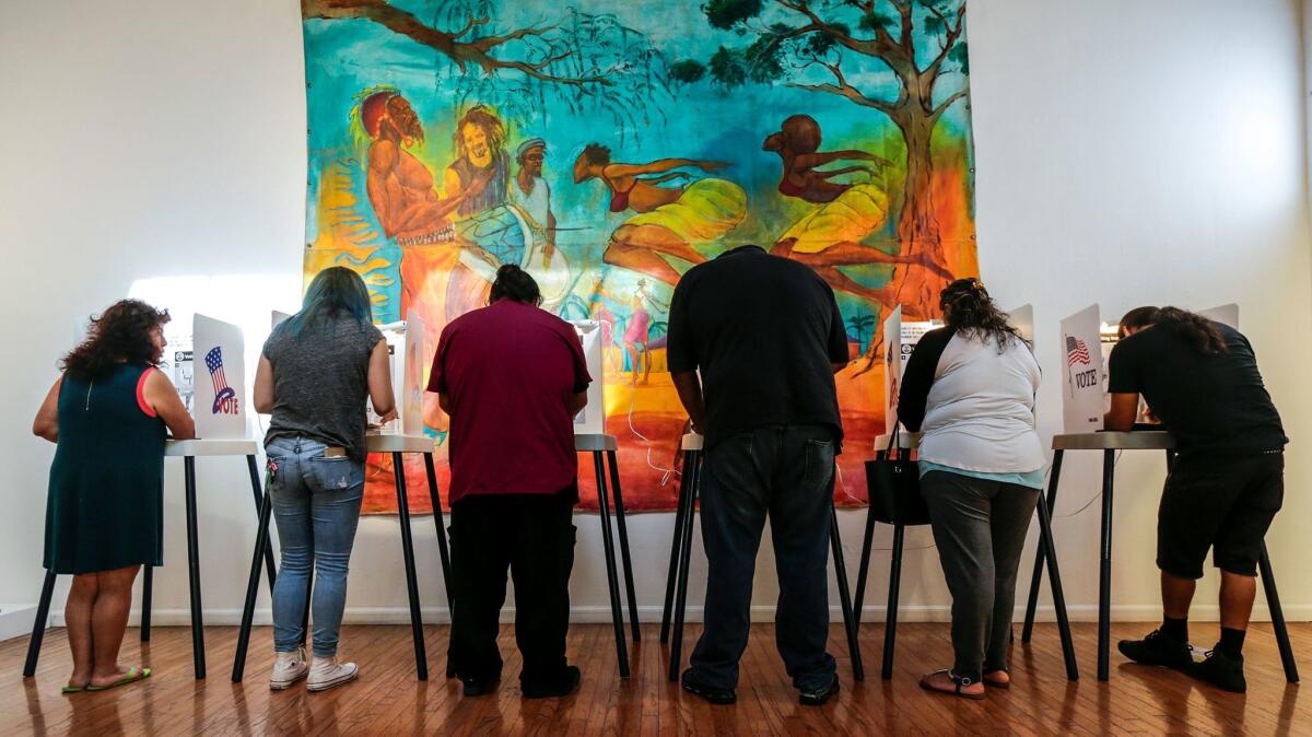 Voters cast ballots at a polling station in Watts Towers Arts Center in November. (Irfan Khan / Los Angeles Times)