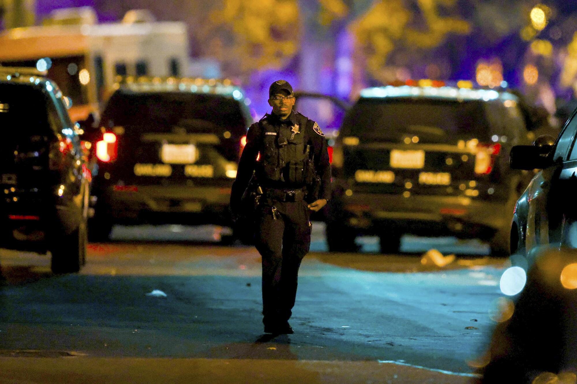 A police officer and several police vehicles.