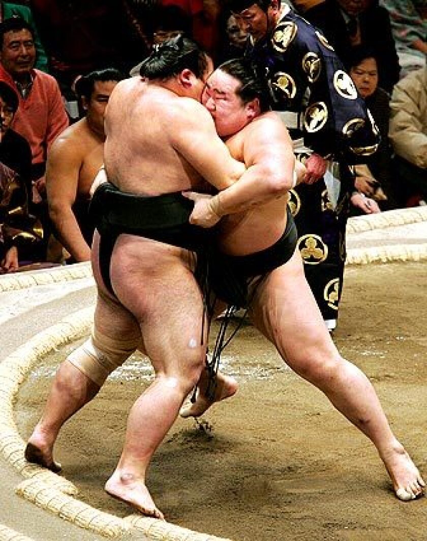 TROUBLE AHEAD: Grand champion Asashoryu, right, earns a victory in January before this months defeats.