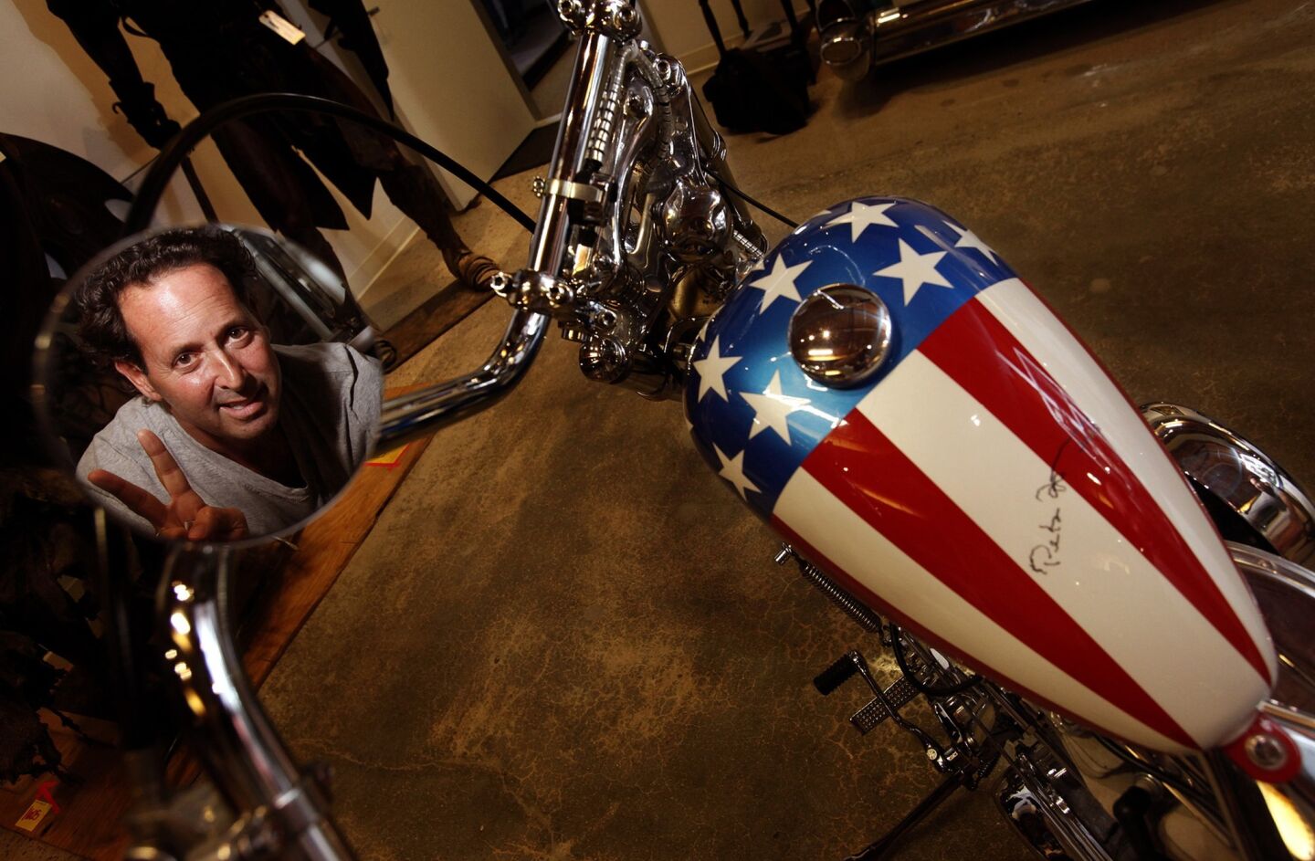 Michael Eisenberg is reflected in the side-view mirror of his "Captain America" chopper. Eisenberg bought the bike in early 2014 from John Parham, a Midwestern motorcycle parts magnate who had purchased the bike from Dan Haggerty 12 years earlier.