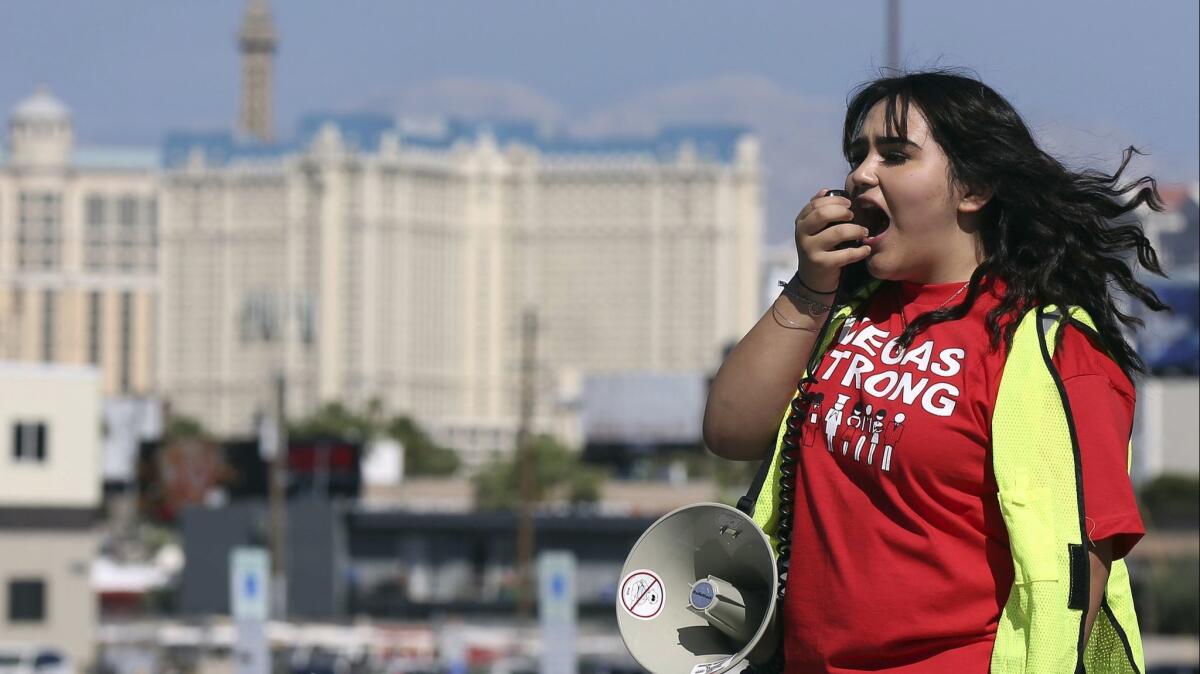 Jenifer Murias yells into a megaphone as Culinary Union members line up to vote on whether to authorize a strike in Las Vegas.