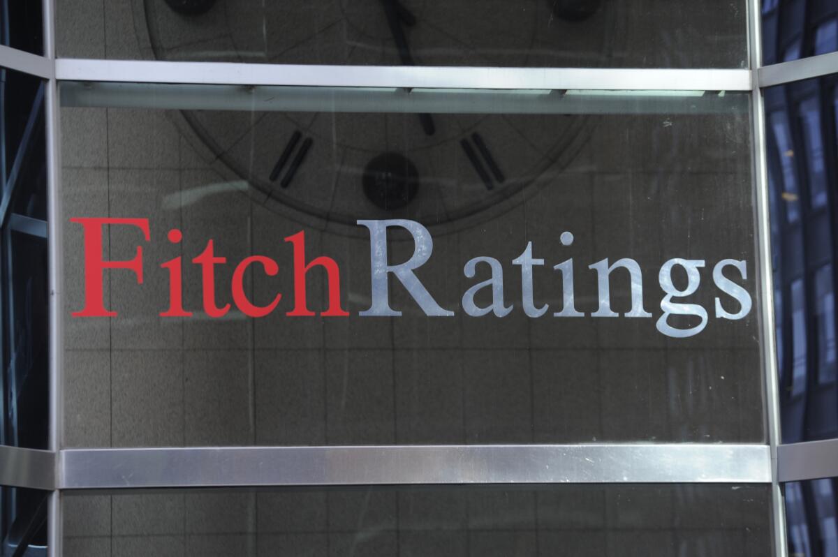 The words Fitch Ratings appear in red and light blue against a dark background 