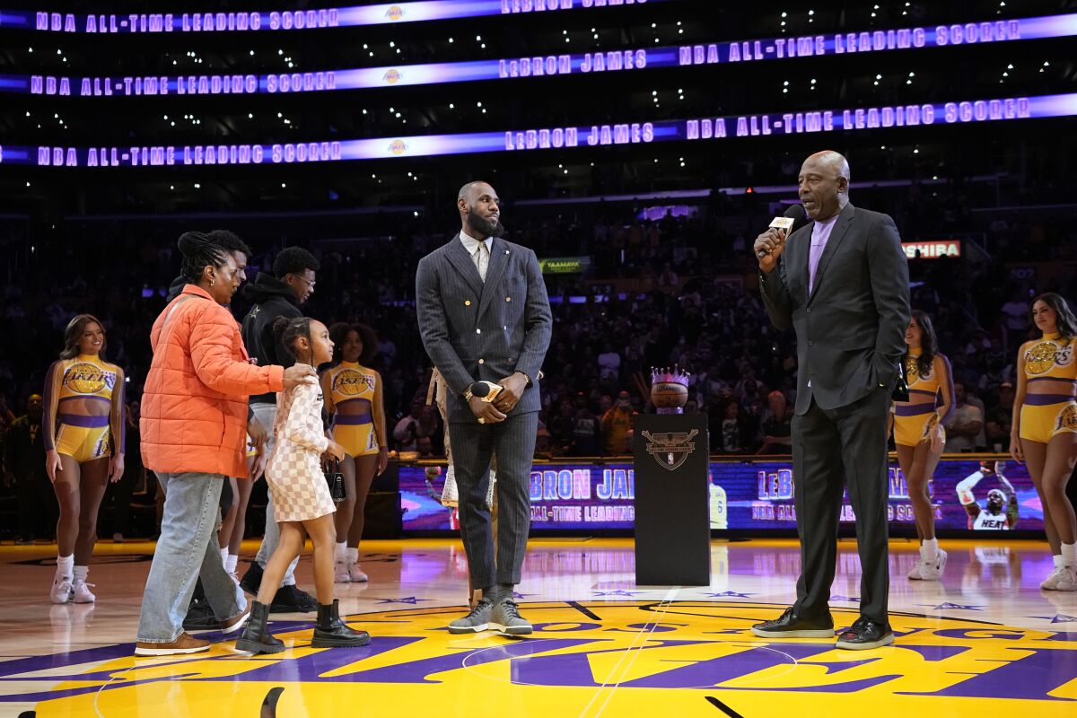 Lakers forward LeBron James is introduced by former Laker James Worthy during a ceremony.