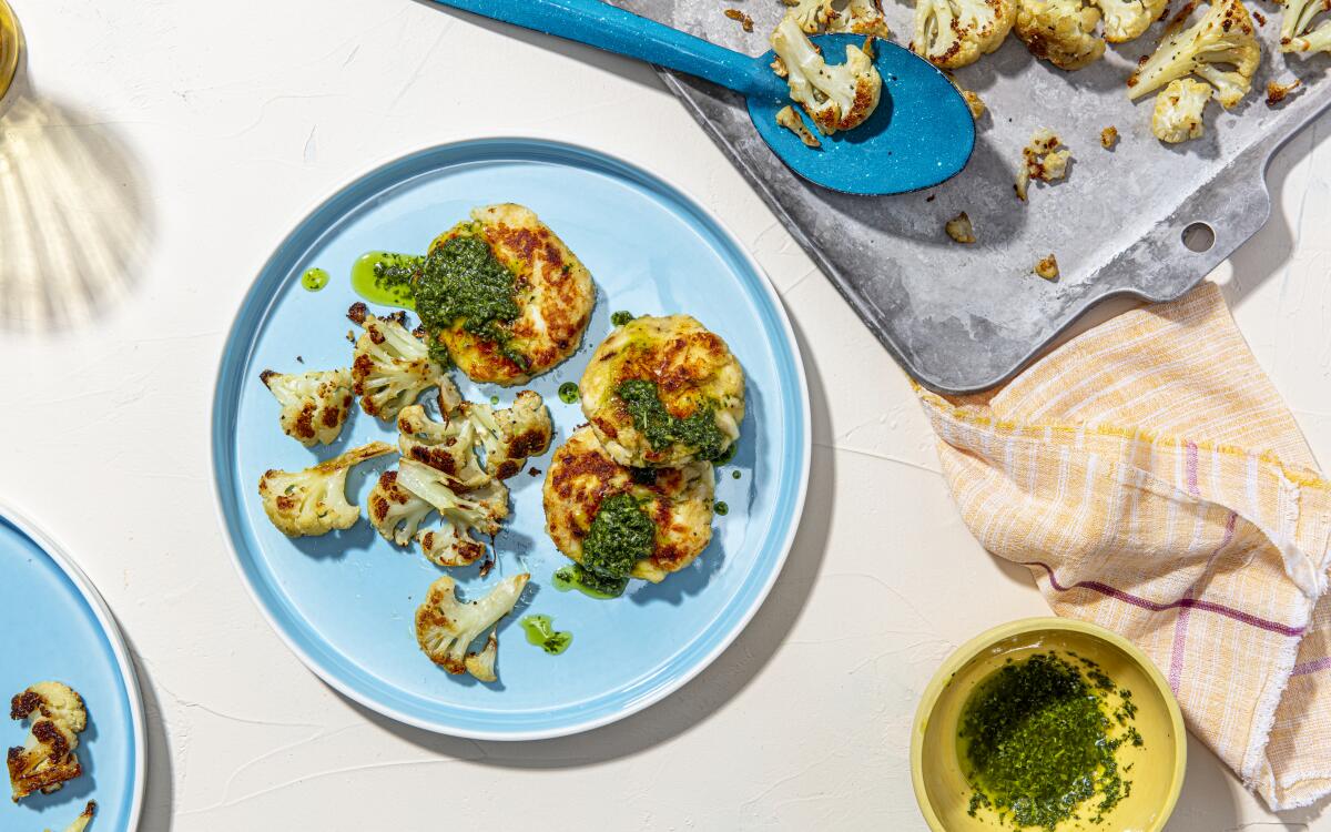 Pan-fried fish cakes with salsa verde and roast cauliflower.