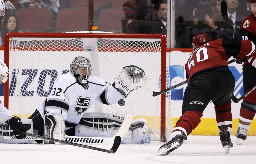 Jonathan Quick reaches up to make a save on a shot by Coyotes forward Antoine Vermette, right, during the first period of a game on Jan. 23.