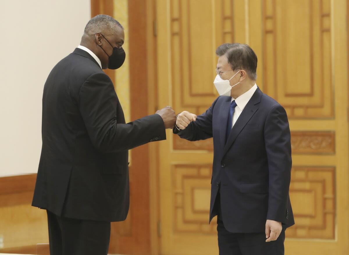 Defense Secretary Lloyd Austin greets South Korean President Moon Jae-in