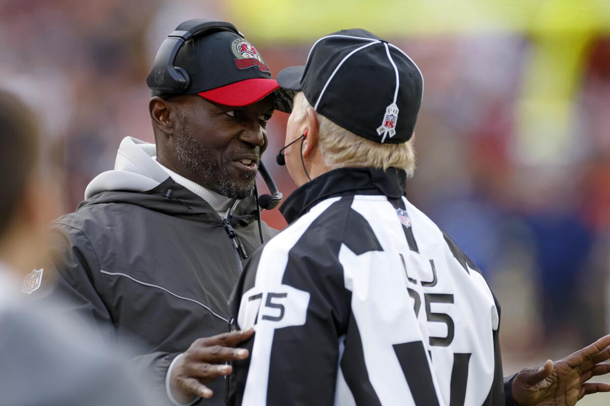 Tampa Bay Buccaneers coach Todd Bowles, left, talks with line judge Mark Stewart during the second half of the team's NFL football game against the Cleveland Browns in Cleveland, Sunday, Nov. 27, 2022. (AP Photo/Ron Schwane)