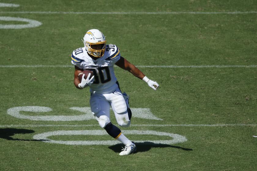 Los Angeles Charger running back Austin Ekeler runs the ball during a game against the Indianapolis Colts in Carson on Sept. 8, 2019.
