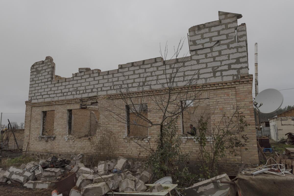 Vadym Zherdetsky stands in the remains of his house destroyed by fighting.