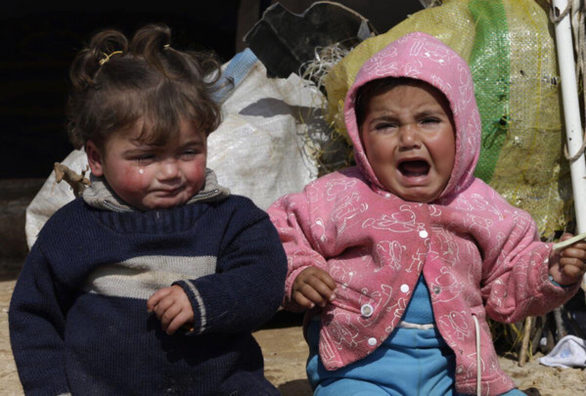 Two toddlers sit outside their family tent at Atmeh refugee camp in the northern Syrian province of Idlib last month. Unicef fears the spiraling conflict may be causing irreparable damage to a generation of Syrian children.